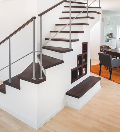 Stufenbelegung - Trittstufen, Pfostenköpfe und Handläufe in Eiche klassik farblos geölt. Setzstufen, Geländerstäbe und Pfosten weiß lackiert. Trittstufen mit Stufenvorderkanten, Stirnseite profiliert und Setzstufen mit abgesetzter Zierfuge. Antrittpfosten mit aufgesetzter Handlaufschnecke. Handlauf mit integrierter LED-Beleuchtung.