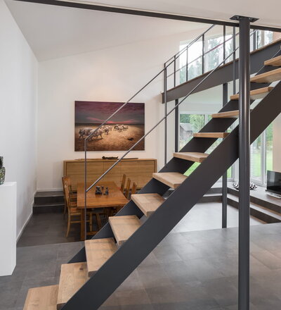 Gerade HPL-Treppe, Stufen in der Holzart Eiche mosaik astig geölt. Geländer und Brüstung aus Stahl im "Goldenen Schnitt"